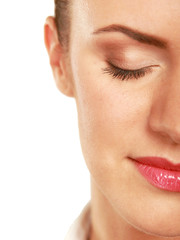 Obraz premium A half of a beautiful female's face, closeup, isolated on white