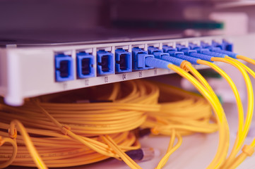 Panel of Fiber network switch with some yellow network cables