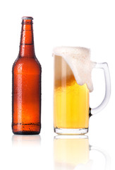 Frosty glass of light beer with bottle isolated