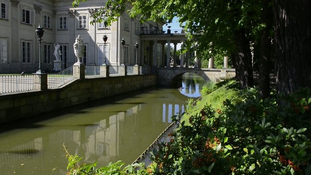 Bridge to royal palace on water in Lazenki park, Warsaw, Poland