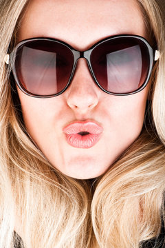 studio closeup portrait of a young beautiful woman in sunglasses