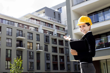 Female construction engineer show building