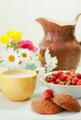 Still life with strawberries and cup of milk