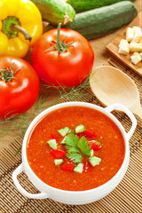 Gazpacho and ingredients on a table, vegetable soup