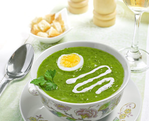 Cream soup with egg, sour cream and wine on the table