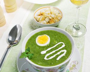 Cream soup with egg, sour cream and wine on the table