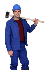 Construction worker holding a large mallet hammer