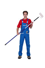 young painter posing with roller