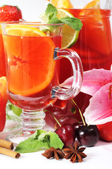 Refreshment beverage in glass with fruits and spice