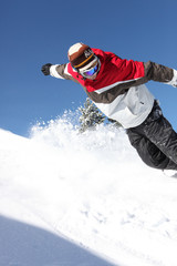Fototapeta na wymiar Snowboarding Man down hill