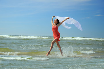 Romantic  woman running on the beach