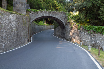 Winding road crossing a roman stone bridge