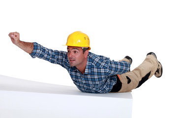 Manual worker in superman pose