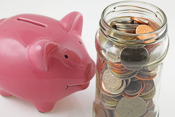 saving jar with uk coins v piggy bank