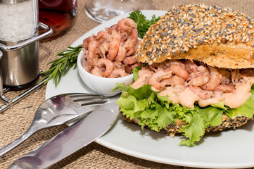 Shrimps on a roll against rustic background