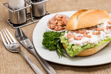 Shrimps on a roll (wooden background)