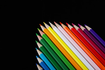 Colorful pencils on black background