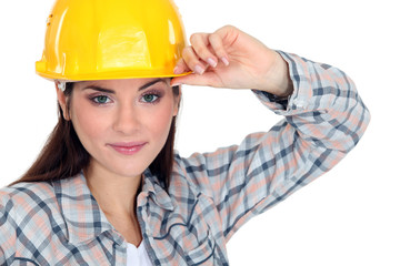 Woman touching the brim of her hard hat