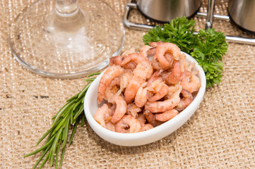 Small bowl with Shrimps on rustic background