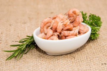 Small bowl with Shrimps on rustic background