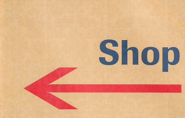 Shop sign with arrow on canvas background