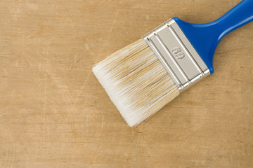 colorful paintbrush on wood background