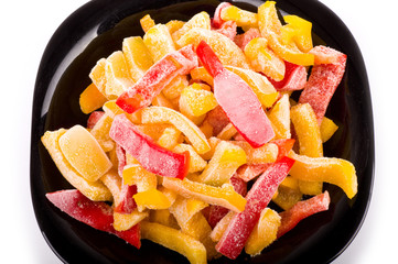Red and yellow pepper in black plate