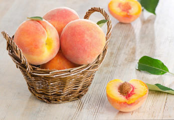 Fresh peaches  in the basket on a wooden table