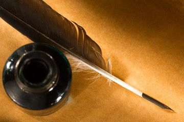 Feather ink bottle on paper