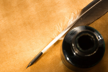 Feather ink bottle on paper