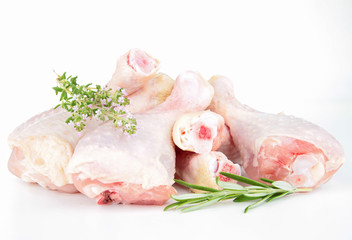 isolated raw chicken drumsticks