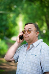 Caucasian man with cell phone in nature