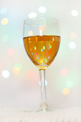 Glass of White Wine with Lights Background