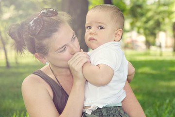 Mother kissing her son's hand