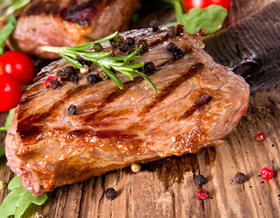Delicious beef steak on wooden planks