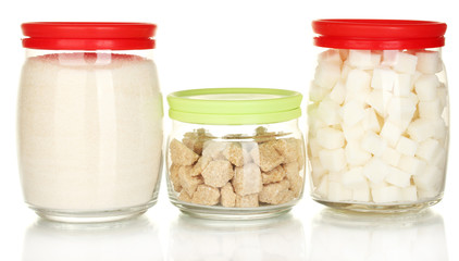 Jars with brown cane sugar lump, white crystal sugar and white