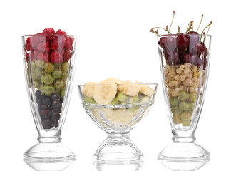 Mixed fruits and berries in glasses isolated on white
