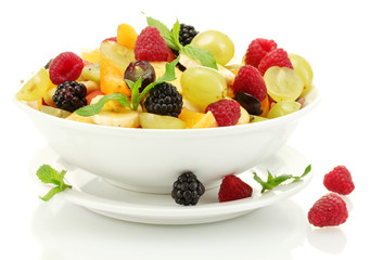 fresh fruits salad in bowl  and berries, isolated on white
