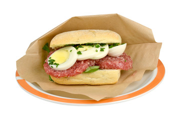 Roll sausage with oxen sausage and egg on a white background.