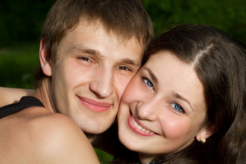 photo of lying couple lying on the grass