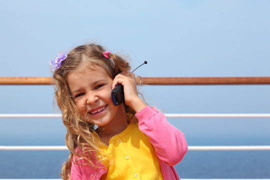 girl stands on board ship and says by portable radio phone
