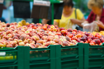 Bunch of paeches and nectarines in boxes in supermarket