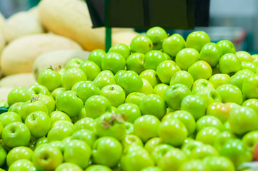 Bunch of fresh green apples in supermarket