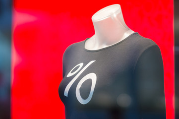 Mannequin with percent sign on cloth in mall