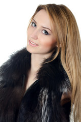 The beautiful girl in a fur vest  isolated