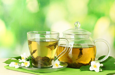 green tea with jasmine in cup and teapot