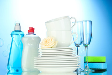empty clean plates, glasses and cups with dishwashing liquid