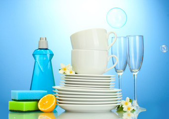 empty clean plates, glasses and cups with dishwashing liquid,