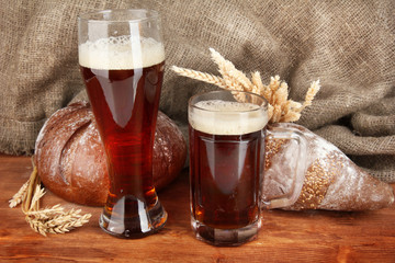 two glasses of kvass with bread on canvas background close-up