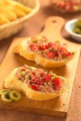 Baguette with tuna, green olive and tomato spread